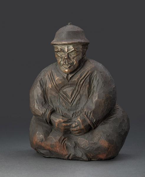 Pisapapeles de hombre sentado